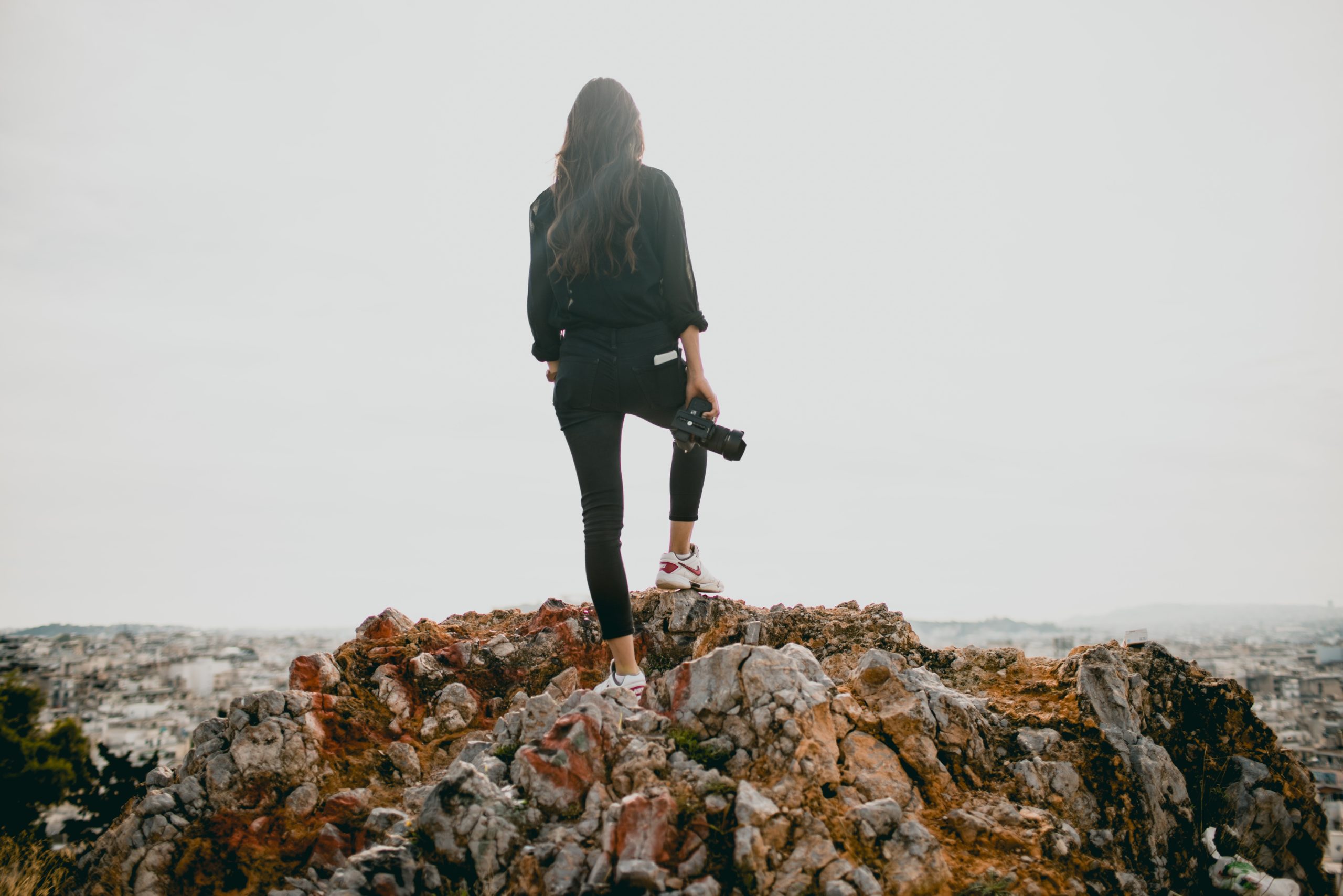 Female photographer on rocks looking at view